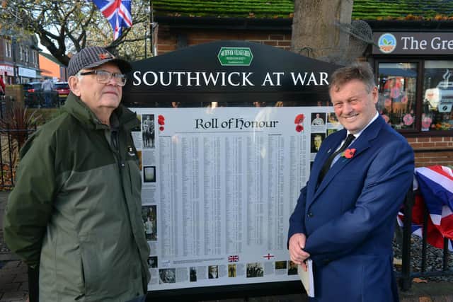 Southwick Village Green Preservation Society chair Peter Gibson (R) with fellow committee member Jim Bryce with the new war panel installation.