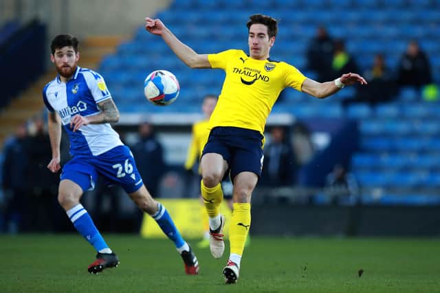 OXFORD, ENGLAND - JANUARY 23: Alex Rodriguez of Oxford United controls the ball watched by Jack Baldwin during the Sky Bet League One match between Oxford United and Bristol Rovers at the Kassam Stadium on January 23, 2021 in Oxford, England. Sporting stadiums around the UK remain under strict restrictions due to the Coronavirus Pandemic as Government social distancing laws prohibit fans inside venues resulting in games being played behind closed doors. (Photo by David Rogers/Getty Images)