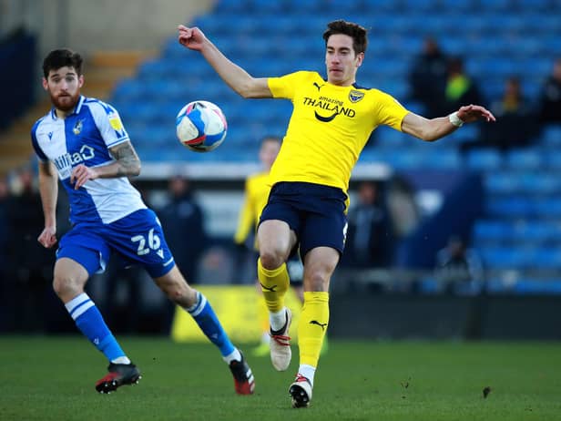 OXFORD, ENGLAND - JANUARY 23: Alex Rodriguez of Oxford United controls the ball watched by Jack Baldwin during the Sky Bet League One match between Oxford United and Bristol Rovers at the Kassam Stadium on January 23, 2021 in Oxford, England. Sporting stadiums around the UK remain under strict restrictions due to the Coronavirus Pandemic as Government social distancing laws prohibit fans inside venues resulting in games being played behind closed doors. (Photo by David Rogers/Getty Images)