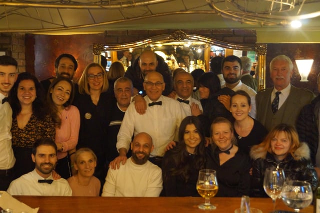 Staff gather for the final night at the restaurant.