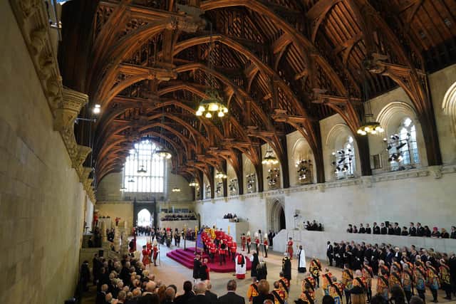 The bearer party carries the coffin of Queen Elizabeth II into Westminster Hall, London, where it will lie in state ahead of her funeral on Monday. Picture date: Wednesday September 14, 2022.