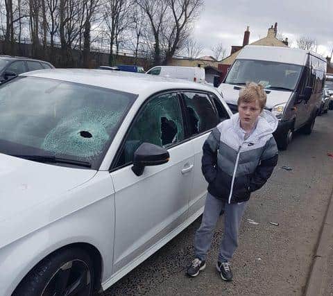 Charlie pictured with the damaged car following the attack on March 23