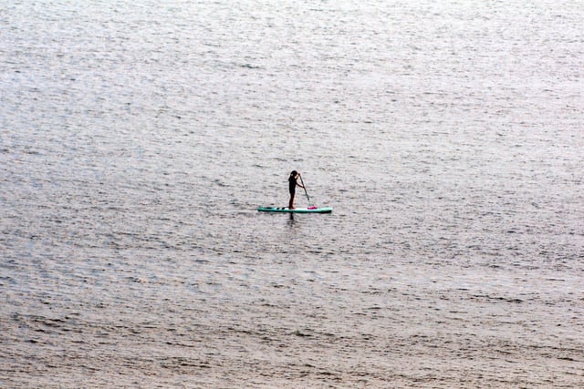 A paddleboarder makes the most of the sunshine
