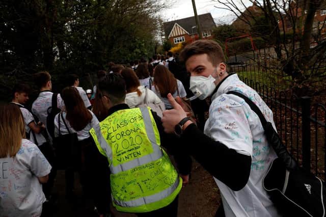 Year 11 pupils react as they leave a secondary school on March 20 (Photo: ADRIAN DENNIS/AFP via Getty Images)