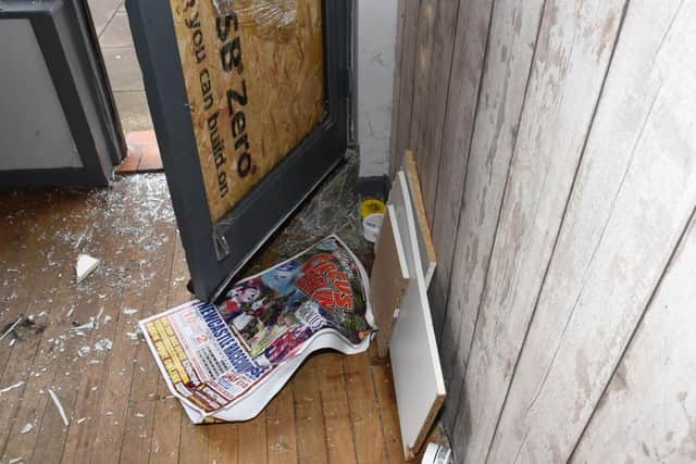 Damage to the doorway of the barber shop after the break-in.