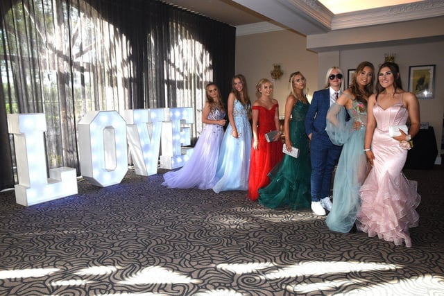 Year 11 girls in their prom dresses and suit.
