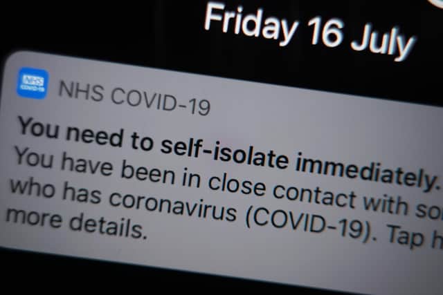 A notification issued by the NHS coronavirus contact tracing app - informing a person of the need to self-isolate immediately, due to having been in close contact with someone who has coronavirus - is displayed on a mobile phone in London, during the easing of lockdown restrictions in England. Picture date: Friday July 16, 2021.