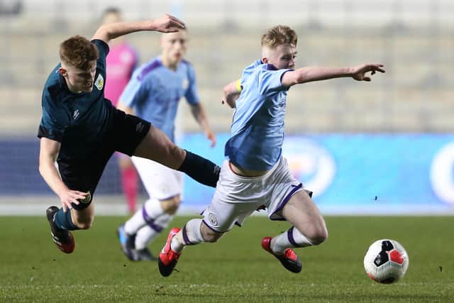 MANCHESTER, ENGLAND - MARCH 04: Ben Woods of Burnley tackles Tommy Doyle of Manchester City during the FA Youth Cup match between Manchester City and Burnley at The Academy Stadium on March 04, 2020 in Manchester, England. (Photo by Charlotte Tattersall/Getty Images)