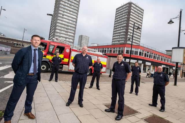 Marc Edwards Gentoo's associate director property investment with members of Tyne and Wear Fire and Rescue Service
