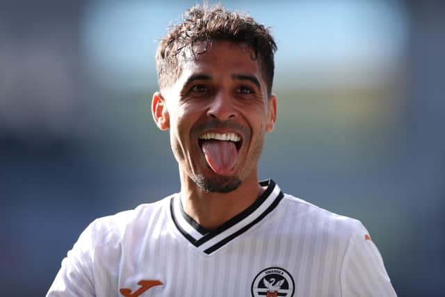 CARDIFF, WALES - APRIL 02: Kyle Naughton of Swansea City interacts with the crowd as they celebrate their side's win after the final whistle of the Sky Bet Championship match between Cardiff City and Swansea City at Cardiff City Stadium on April 02, 2022 in Cardiff, Wales. (Photo by Ryan Hiscott/Getty Images)