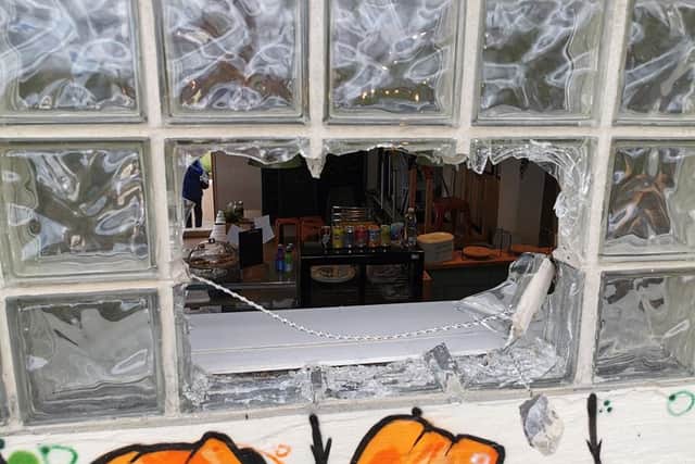 A photo shows how the glass bricks of the coffee shop were damaged in the burglary.