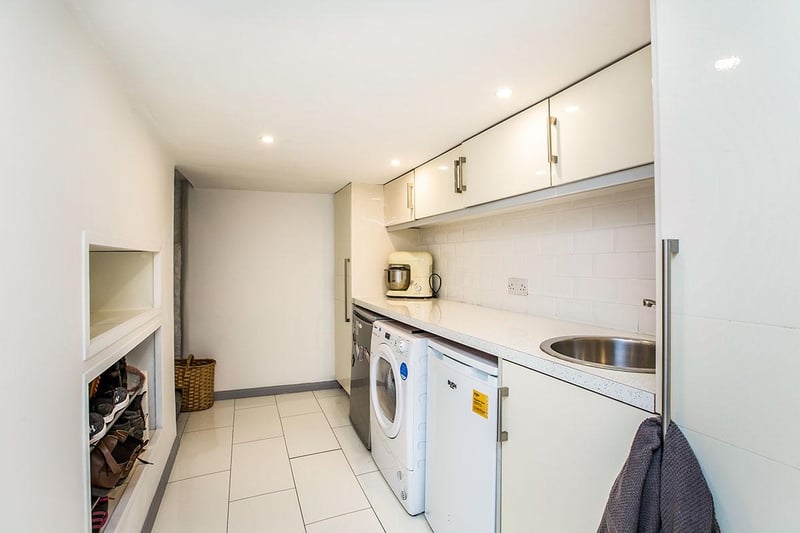 The room benefits from polished granite surfaces and an inset stainless steel sink.