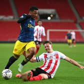 SUNDERLAND, ENGLAND - OCTOBER 13: Manchester United player Dillon Hoogewerf is challenged by Sunderland captain Denver Hume during the Papa John's Trophy between Sunderland and Manchester United U21 at Stadium of Light on October 13, 2021 in Sunderland, England. (Photo by Stu Forster/Getty Images)