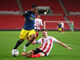 SUNDERLAND, ENGLAND - OCTOBER 13: Manchester United player Dillon Hoogewerf is challenged by Sunderland captain Denver Hume during the Papa John's Trophy between Sunderland and Manchester United U21 at Stadium of Light on October 13, 2021 in Sunderland, England. (Photo by Stu Forster/Getty Images)