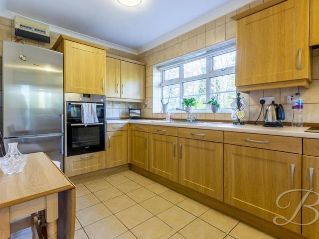 The second of three images of the bungalow's kitchen, which has space for all you need, including a fridge/freezer. There is also an inset sink and drainer, integrated oven, electric hob and extractor fan.
