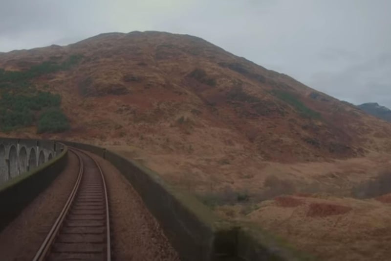 A view from the driver's cab of a train crossing the Glenfinnan Viaduct.