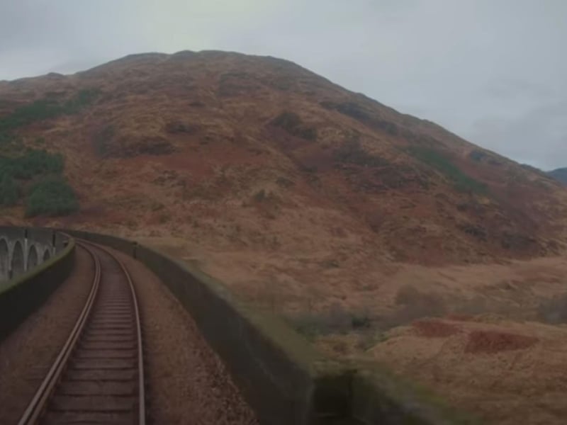 A view from the driver's cab of a train crossing the Glenfinnan Viaduct.