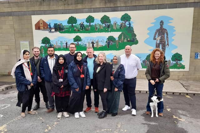 Artist Chad McCail, centre, with some of the people (and one animal) who helped him to create the mural. Sunderland Echo image.