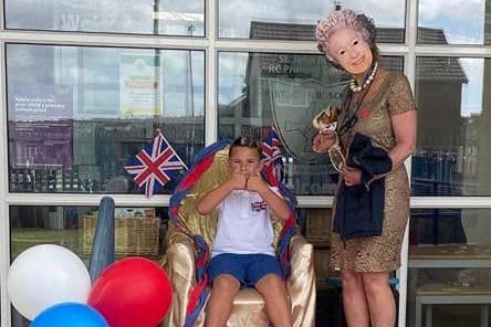 Daley Boyes, age 6, from St John Bosco Primary School with the 'Queen'.