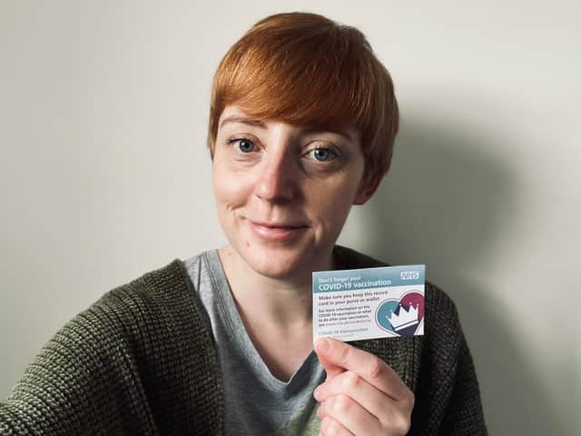 Debra with her Covid vaccine appointment card.
