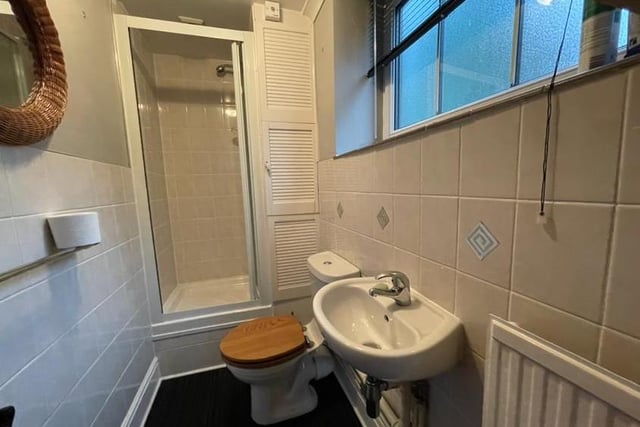 Before we head upstairs, let's take a look at this shower room, which can be found on the ground floor. It is fitted with a three-piece suite comprising a shower enclosure, low-flush WC and wash hand basin, plus tiled walls and a central heating radiator.