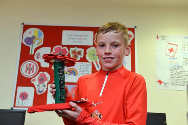 SAFC U12 player Charlie Morton, 11, with his winning poppy design.