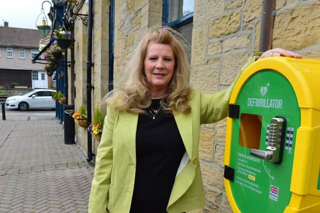 Kimberley Cheetham, general manager of the Cross Keys pub with the new defibrillator. Picture by Frank Reid.