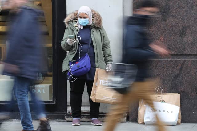 A shopper wears a face mask in London. Picture: PA.