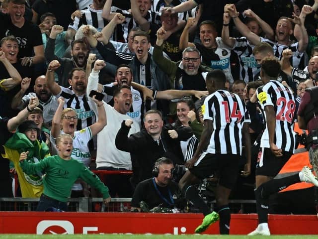 Newcastle United's Swedish striker Alexander Isak (2nd R) celebrates with fans after scoring the opening goal of the English Premier League football match between Liverpool and Newcastle United at Anfield in Liverpool, north west England on August 31, 2022. (Photo by PAUL ELLIS/AFP via Getty Images)