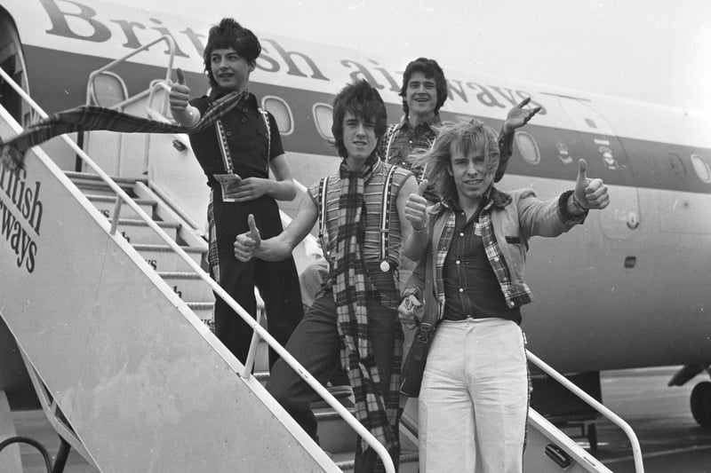 Bay City Rollers Ian Mitchell, Les McKeown, (front) Stuart Wood  and Derek Longmuir board a plane at Edinburgh airport for a promotional tour of the USA. in April 1976.