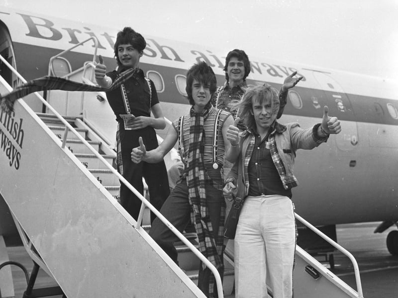 Bay City Rollers Ian Mitchell, Les McKeown, (front) Stuart Wood  and Derek Longmuir board a plane at Edinburgh airport for a promotional tour of the USA. in April 1976.