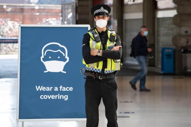 A police officer wears a face mask (Photo by NIKLAS HALLE'N/AFP via Getty Images)
