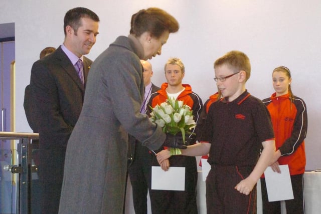 Princess Anne receives a bouquet of flowers from Jay Smythe from the Learn to Swim programme at Sunderland Aquatic Centre in 2009.