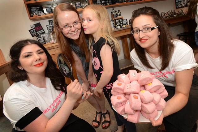 Staff from Lush in The Bridges, Anne-Marie Docherty and Gemma Hassan promoting their Kissathon whilst 7 year old Sophie Bulmer kisses her mum, Sarah Dobinson on the cheek in 2013.