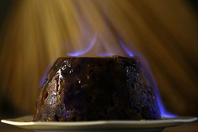 Who's for a slice of Christmas pud? Love it or hate it, the spectacle of it at the dinner table on December 25 is one to enjoy. Picture: Christopher Furlong/Getty Images.