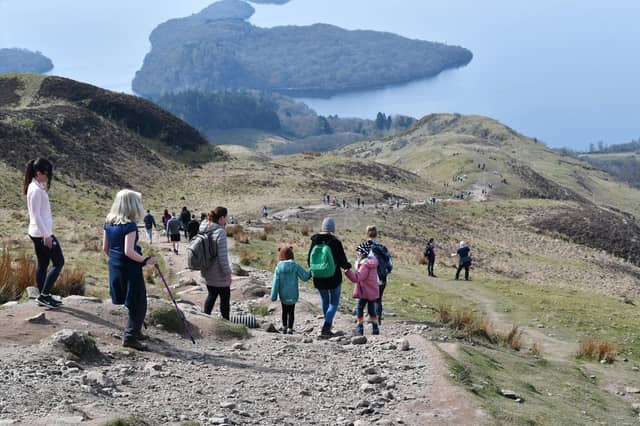 Walkers take to the hills overlooking Loch Lomond as restrictions ease.