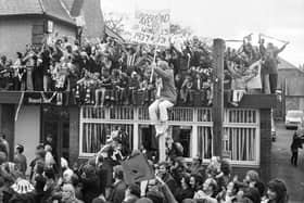 Sunderland fans celebrate their team's victory in the 1973 FA Cup and watch the homecoming parade from the Board Inn, East Herrington.