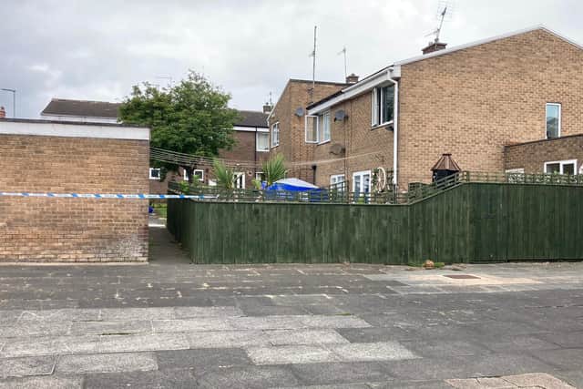 Police sealed off an area at the back of the house following the discovery of a man's body.