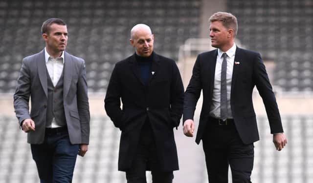 New Newcastle Head Coach Eddie Howe (r) chats with members of his management company on the pitch at his unveiling press conference at St. James's Park.  (Photo by Stu Forster/Getty Images)