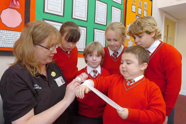 Marecia Edmundson of St, John Ambulance, with pupils at Grindon Hall Christian School, who learned how to bandage someone properly in the event of an accident.