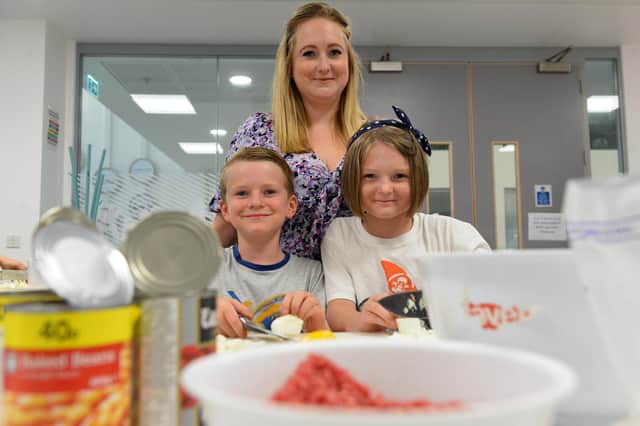 Pearl Bothick, 10, brother Reuben Bothick, 7, and mother Katy Bothick, 35, taking part in the cooking sessions at the Foundation of Light's Beacon of Light.