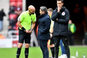 Lee Johnson in dialogue with referee Darren Drysdale