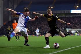 BLACKBURN, ENGLAND - FEBRUARY 06: James McClean of Wigan attempts to cross the ball whilst under pressure from Joe Rankin-Costello of Blackburn Rovers during the Sky Bet Championship between Blackburn Rovers and Wigan Athletic at Ewood Park on February 06, 2023 in Blackburn, England. (Photo by Clive Brunskill/Getty Images)