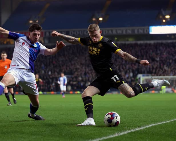 BLACKBURN, ENGLAND - FEBRUARY 06: James McClean of Wigan attempts to cross the ball whilst under pressure from Joe Rankin-Costello of Blackburn Rovers during the Sky Bet Championship between Blackburn Rovers and Wigan Athletic at Ewood Park on February 06, 2023 in Blackburn, England. (Photo by Clive Brunskill/Getty Images)
