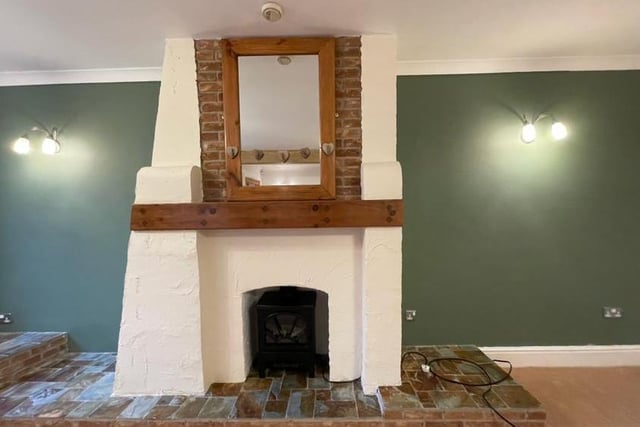 One of the focal points of the large lounge is this characterful feature fireplace with coal-effect gas fire.