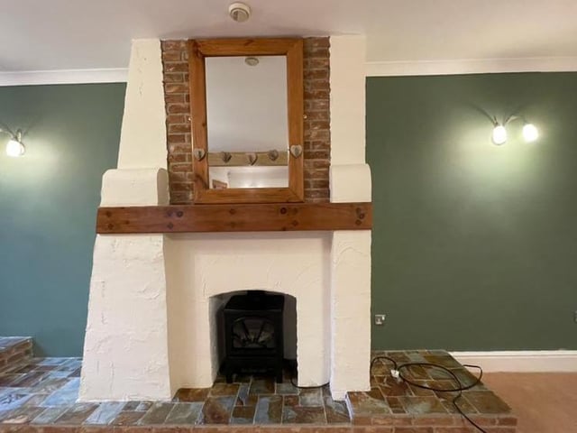 One of the focal points of the large lounge is this characterful feature fireplace with coal-effect gas fire.