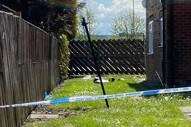 Police tape running across the garden of a house in Avondale Avenue