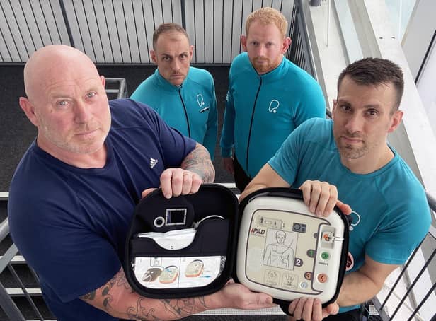 Allan Scott 58 (left) with PureGym staff (left to right) Dan Knott, Andrew Boal-Wallace and Gary Lee who used the defibrillator Alan and Andrew are holding to save his life. 

Picture by FRANK REID