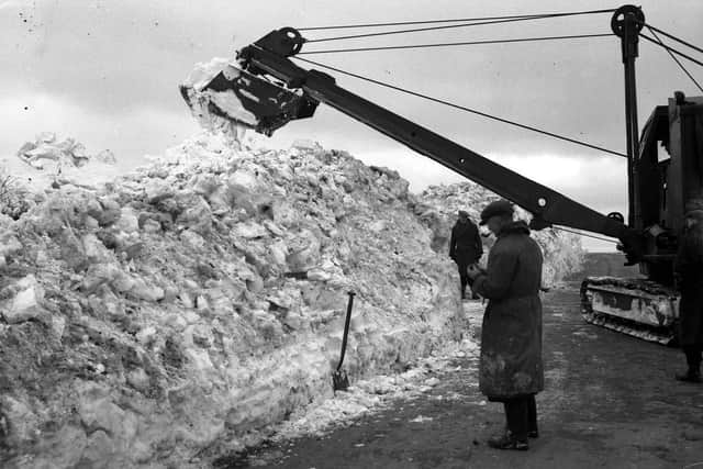 An excavator tackles the huge build-up of snow in 1947.