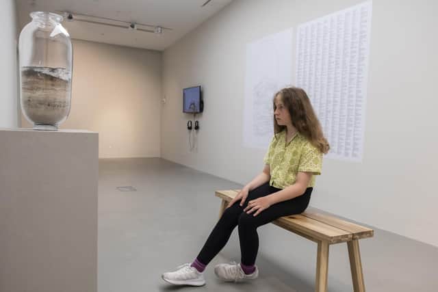 Young Matilda is looking at Earth's history in Katie Paterson's piece at National Glass Centre.